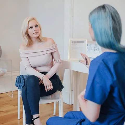 Patient sitting with a nurse in a bright consultation room at Cool Clinic, CoolSculpting fat freezing Dublin